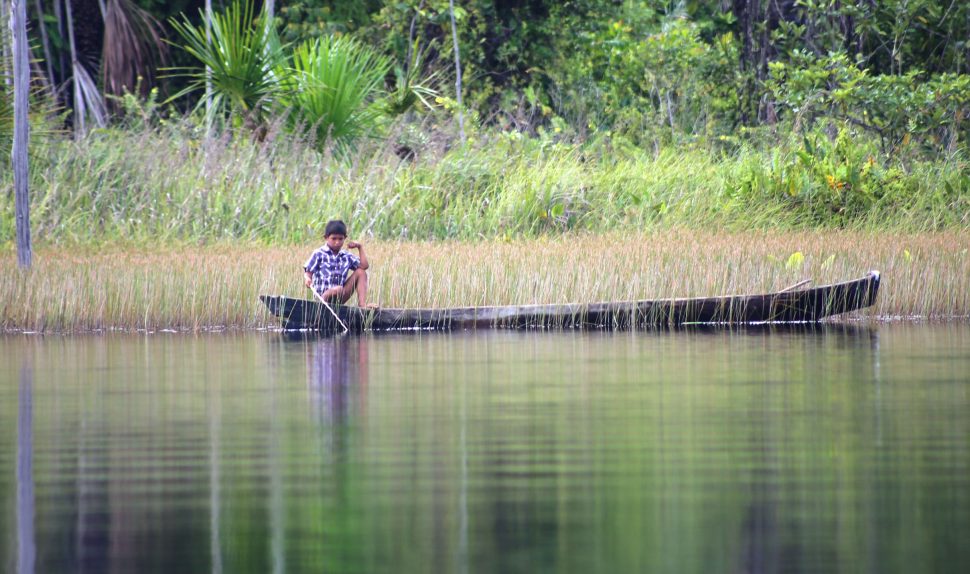 A young boy fishing on the lake