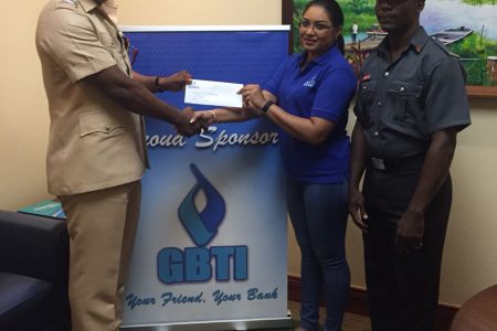  GBTI yesterday handed over a cheque of a $100,000 to the Guyana Fire Service Fire in support of its Fire Prevention Week Activities. In picture, GBTI’s Marketing and Public Relations Manager Pamela Binda presents a cheque to Nigel Gravesande in the presence of Fire Prevention Inspector J. Semple at GBTI’s Kingston Head Office. (GBTI photo)

