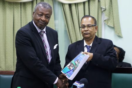 Speaker of the National Assembly Dr. Barton Scotland (left) accepting the 2017 Auditor General’s Report from Auditor General Deodat Sharma at the Public Buildings yesterday. The document will be made public after being laid in Parliament sometime after the recess ends on October 10th. (Photo by Terrence Thompson)