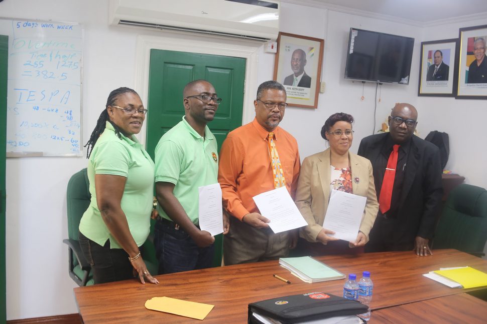 From left with the signed documents are the GTU’s Coretta McDonald and Mark Lyte, Chief Labour Officer Charles Ogle and Education Minister officials Adele Clarke and Marcel Hutson. (Terrence Thompson photo)