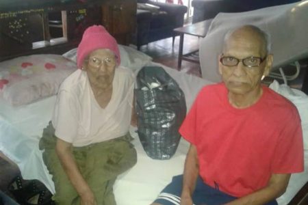 Jasmattie Basdeo, 92, and her son Mahandranauth Basdeo, 72, at Number 64 Village Corentyne Berbice yesterday. (Guyana Police Force photo)