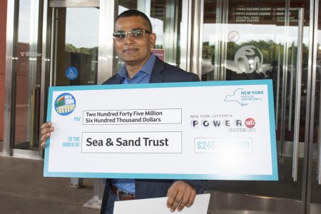Nandlall Mangal with his cheque (New York Post photo)