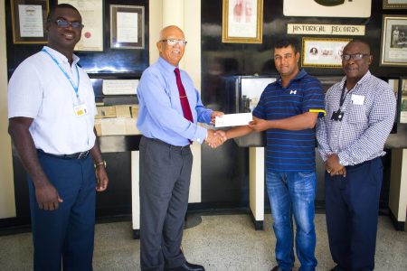 Clifford Reis (2nd from left), Chairman/Managing Director of Banks DIH Limited presents the sponsorship cheque to Avinash Persaud while Gavin Todd and Troy Peters (right) look on
