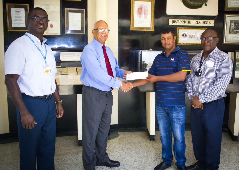 Clifford Reis (2nd from left), Chairman/Managing Director of Banks DIH Limited presents the sponsorship cheque to Avinash Persaud while Gavin Todd and Troy Peters (right) look on
