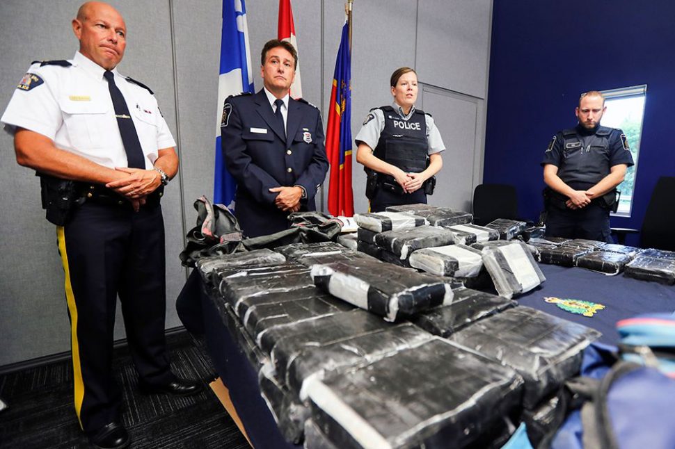 RCMP Inspector Jacques Rainville, left, Alain Surprenant, in charge of intelligence for Quebec region at the Canada Border Services Agency, and RCMP Cpl. Genevieve Byrne with 81 kilos of cocaine seized at the port in Valleyfield. Photo by: John Mahoney / Montreal Gazette	