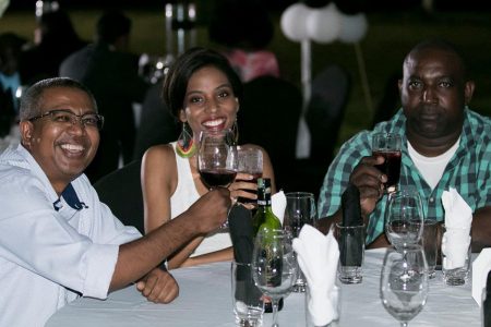 GPL’s Loris Nathoo (left) shares a toast with friends at the recent Guyana Chess Federation fund-raising dinner. He is representing Guyana at the 2018 Chess Olympiad in Georgia.
