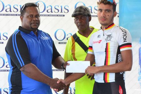Paul De Nobrega receives his first place prize from a representative of the sponsors. (Orlando Charles photo)
