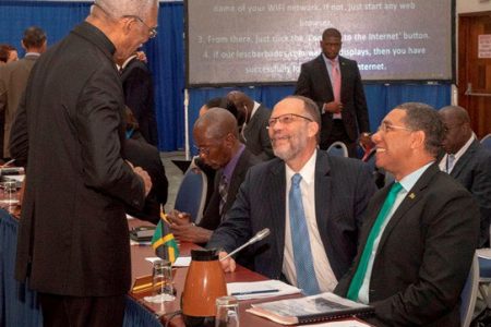 President David Granger (standing) chats with CARICOM Secretary General Irwin LaRocque (seated second from right) and Jamaican Prime Minister Andrew Holness (seated at right) during the Ninth Prime Ministerial Sub-Committee Meeting of the Single Market and Economy. (DPI photo)