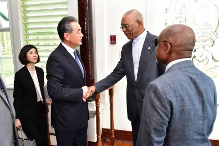 President David Granger (second from right) greeting Chinese Foreign Minister Wang Yi today at State House  (Ministry of the Presidency photo)