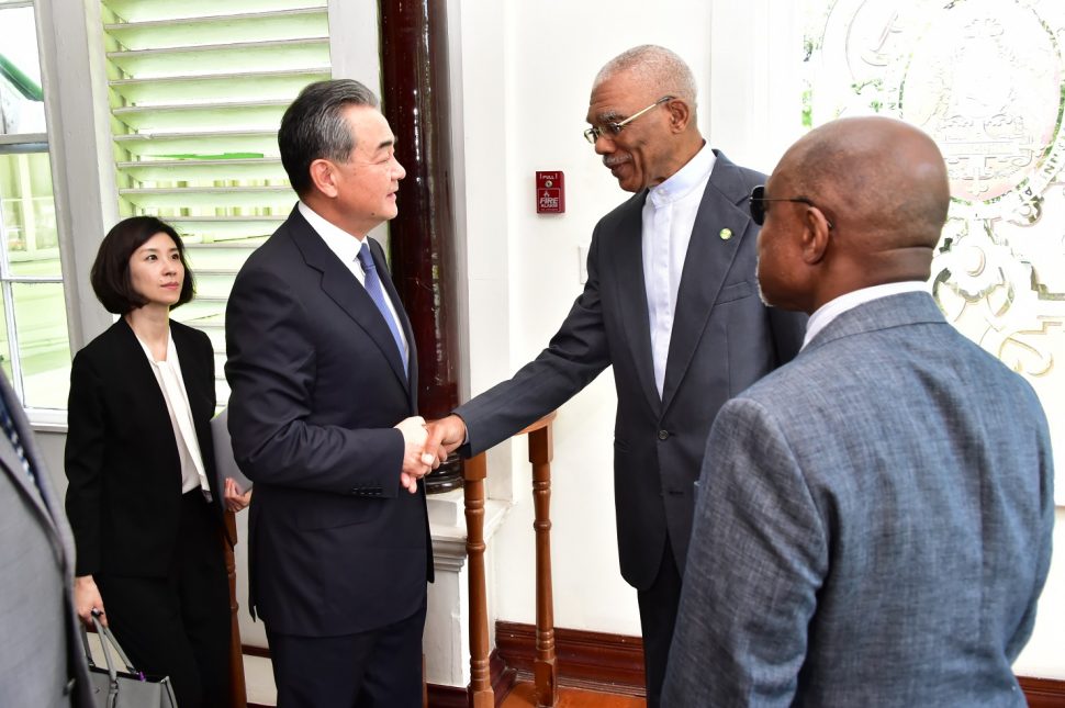 President David Granger (second from right) greeting Chinese Foreign Minister Wang Yi today at State House  (Ministry of the Presidency photo)