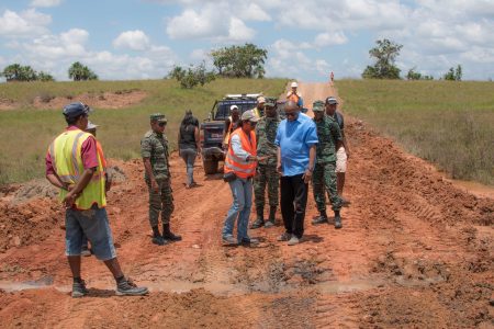 Minister of State, Joseph Harmon (third from right) and members of the reconnaissance team inspect this site along the  Karaudanawa trail, where works have begun for the construction of a culvert. (Ministry of the Presidency photo)