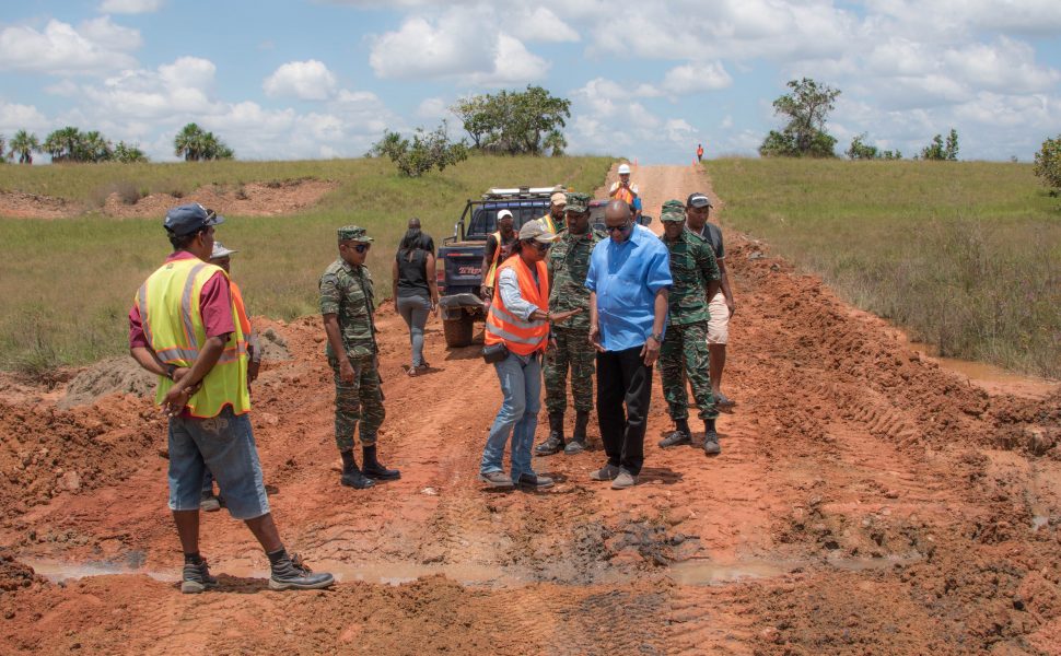 Minister of State, Joseph Harmon (third from right) and members of the reconnaissance team inspect this site along the  Karaudanawa trail, where works have begun for the construction of a culvert. (Ministry of the Presidency photo)