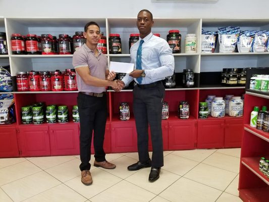 CEO of the nation’s premier supplement and gym equipment supplier, Jamie McDonald recently presented a cheque to Kerwin Clarke to help offset expenses for next week’s Darcy Beckles Championships in Barbados.