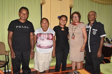 Nellisha Johnson (centre) is flanked by her parents and coach (L-R) Glen Johnson, Carmelita Johnson, Minister Valerie Garrido-Lowe and Coach Roy Sharma.
