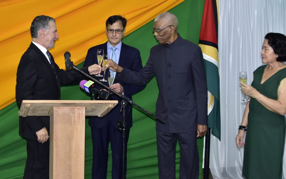 President David Granger (second from right) sharing a toast with Brazil’s Ambassador to Guyana, Lineu Pupo De Paula. First Lady Sandra Granger is at right. (Ministry of the Presidency photo)