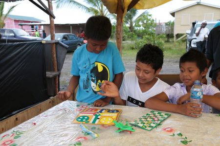  These lads were engrossed in board games at yesterday’s Amerindian heritage day event at Swan off the Linden/Soesdyke Highway. (Photo by Joanna Dhanraj)