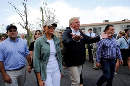U.S. President Donald Trump and first lady Melania Trump walk through a neighborhood damaged by Hurricane Maria in Guaynabo, Puerto Rico, U.S., October 3, 2017. REUTERS/Jonathan Ernst/File Photo