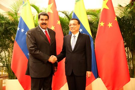 Venezuela’s President Nicolas Maduro (left) and Chinese Premier Li Keqiang shake hands during their meeting in Beijing, China September 14, 2018. Miraflores Palace/Handout via REUTERS