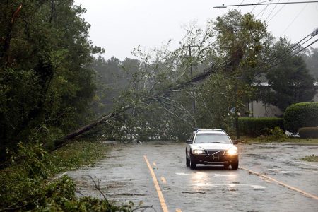 A motorist drives away from a fallen tree blocking a road after the arrival of Hurricane Florence in Wilmington, North Carolina, U.S., September 14, 2018. REUTERS/ Jonathan Drake