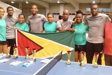 The Guyana male and female table tennis teams following their silver medals performances Monday night. At right is GTTA vice president Gary Pratt. Missing is U21 female player Priscilla Greaves.
