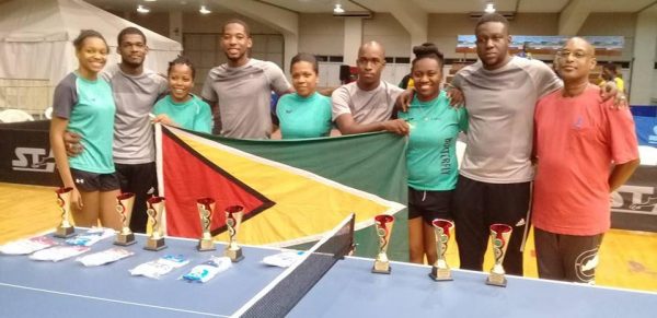 The Guyana male and female table tennis teams following their silver medals performances Monday night. At right is GTTA vice president Gary Pratt. Missing is U21 female player Priscilla Greaves.
