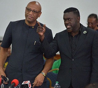 President of the Public Services Association (PSA) Watson Duke, right, makes a point to Oilfield Workers Trade Union (OWTU) President-General Ancel Roget, during a press conference at Palms Club, San Fernando, on Tuesday. 