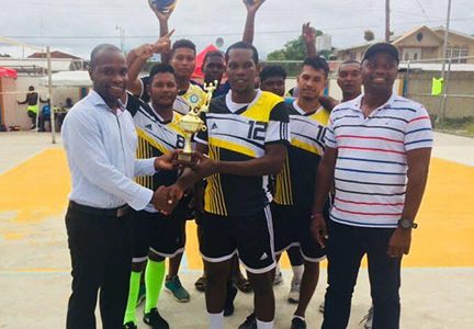 Gifford Marshall, Mayor of Bartica hands over the winning trophy to Bartica Warriors on Sunday in the presence of DVA president Trevor Williams. 