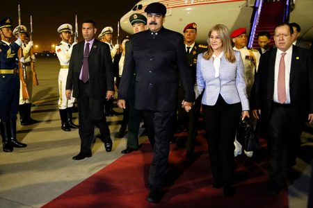 Venezuela’s President Nicolas Maduro walks with his wife Cilia Flores upon their arrival at the airport in Beijing, China September 13, 2018. Miraflores Palace/Handout via REUTERS