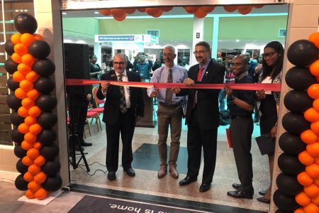 From left are Ashley Furniture Homestore representative Jesus Dacal; Business Minister Dominic Gaskin; Managing Director of Unicomer Clyde de Haas, and Ashley Furniture Homestore Manager Romel Richmond along with Purchasing Manager Kayeann Moore cutting the ribbon to declare the store open yesterday morning. 