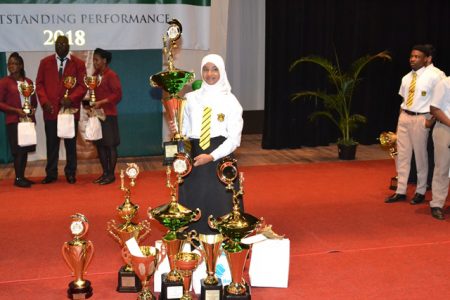 Aadilah Ali with the awards she received for her outstanding performances. (Department of Public Information photo)