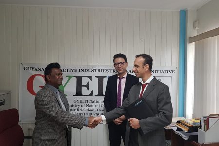 National Coordinator of the National Secretariat of the Guyana Extractive Industries Transparency Initiative (GYEITI) Dr Rudy Jadoopat (left) meeting with two representatives from the International Administrator – Moore Stephens LLP.
