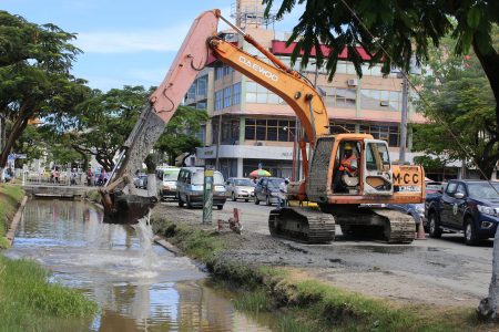 Clearing the canal: The city council dredging the Avenue of the Republic canal yesterday.  (Terrence Thompson photo)