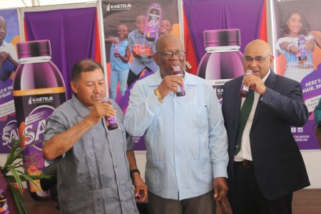 From left, Minister of Indigenous Peoples’ Affairs, Sydney Allicock; Minister of Finance, Winston Jordan; and Dr Suresh Narine of the IAST sampling the new ‘SAK’ juice made of local purple sweet potatoes. 