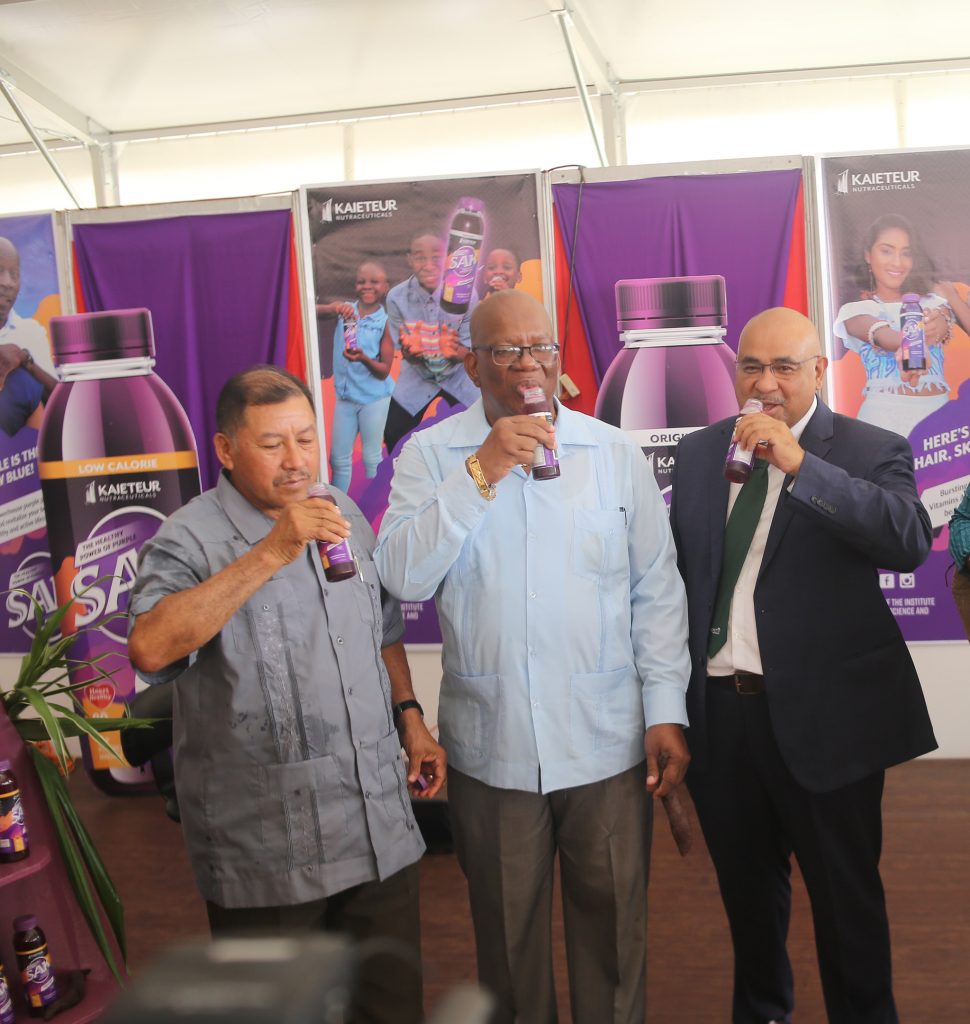 From left, Minister of Indigenous Peoples’ Affairs, Sydney Allicock; Minister of Finance, Winston Jordan; and Dr Suresh Narine of the IAST sampling the new ‘SAK’ juice made of local purple sweet potatoes. 