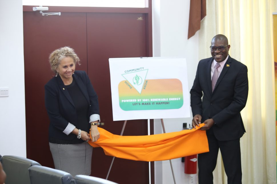 The campaign logo being unveiled yesterday by Minister of Public Infrastructure David Patterson (left) and Inter-American Development Bank Mission Head Sophie Makonnen. (Photo by Terrence Thompson)  