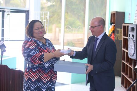 Archivist of the National Archives of Guyana Nadia Gamel-Carter receives a package of the restored materials from the ‘Dutch Collection’ from the Head of Digitisation of the National Archives of the Netherlands Arjan Agema. (Photo by Terrence Thompson)