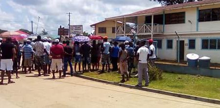 Some of the protesters on Tuesday in front of the Guyana Geology and Mines Commission’s Mahdia office.