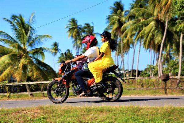 A couple passing through the village on their motorcycle
