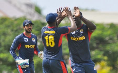 CCC Marooners skipper Carlos Brathwaite (right) celebrates another wicket with Akeem Jordan and wicketkeeper Amir Jangoo.
