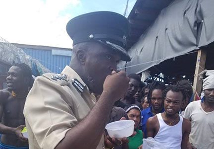 Director of Prisons Gladwin Samuels sampling the food before it was served to inmates yesterday morning at the Lusignan Prison.  