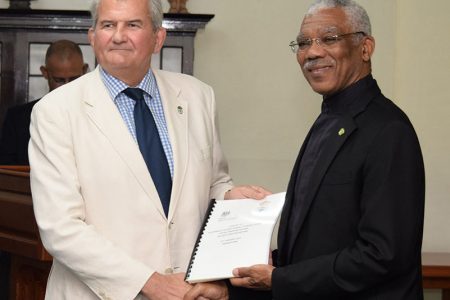 Lt Col (rtd) Russell Combe (at left) handing over the plan to President David Granger in January