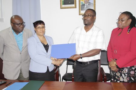The Ministry of Education and the Guyana Teachers’ Union on Wednesday signed an agreement on conditions of employment for teachers/teacher educators after months of wrangling and a brief strike. The agreement, a joint statement from the two sides said, pertains to salary and non-salary benefits. The statement said that a copy of the agreement will be made public shortly.
From left are Marcel Hutson and Adele Clarke of the Ministry of Education and Mark Lyte and Coretta McDonald of the GTU.
