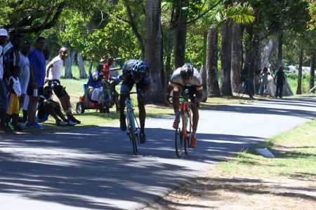 Briton John (left) pipped Paul DeNobrega at the line in a thrilling two-man sprint finish yesterday at the National Park. (Orlando Charles photo)