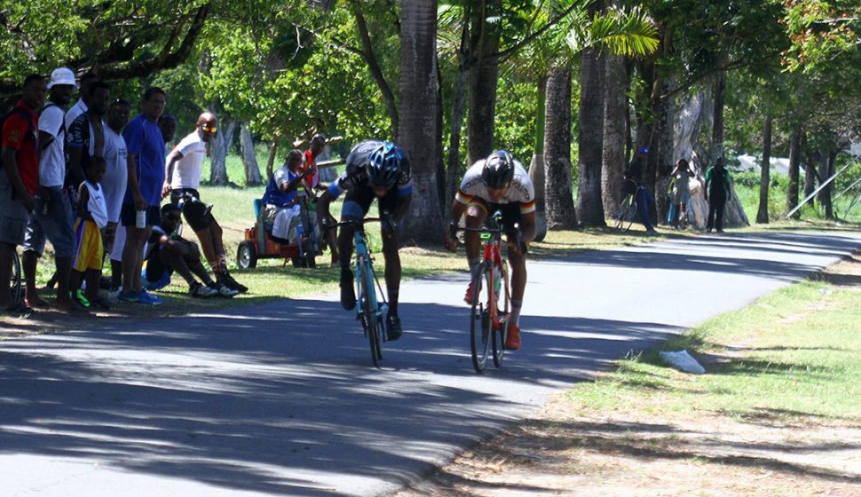 Briton John (left) pipped Paul DeNobrega at the line in a thrilling two-man sprint finish yesterday at the National Park. (Orlando Charles photo)