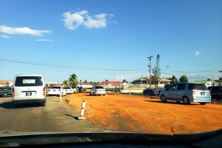 Drivers using a section of the unfinished road in a bid to bypass the snail-paced traffic. (East Coast Demerara Road Project Issues Photo)