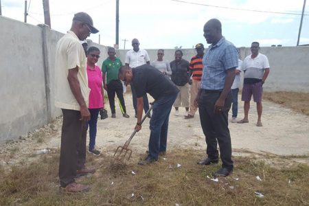 Secretary of GCB, Anand Sanasie turning the sod, in the presence of Alvin Johnson, ECB Executive Member (left), Raywattie Autar, Vice Chairperson of the NDC (partially hidden) and Colin Stuart, TDO of the GCB (right)