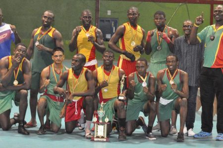 Quincy Boyce (at centre with the best boxer award) and the GDF outfit pose for a photo after the curtain came down on this year’s Lennox Blackmore Intermediate Championships Sunday night at the National Gymnasium.
