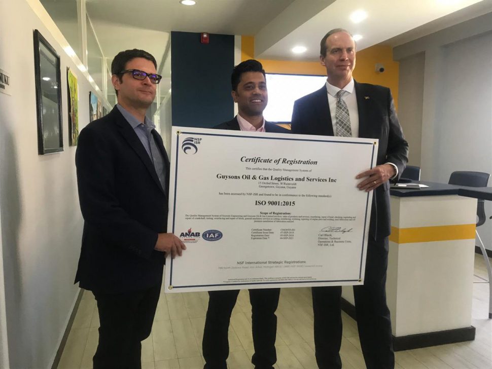 From left are Project Director of ExxonMobil’s Centre for Local Business Development Patrick Henry, CEO of Guysons Oil and Gas Services Faizal Khan and Operations Manager of ExxonMobil (Guyana) Mike Ryan holding the ISO certification