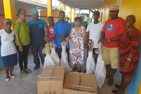Minister of Social Protection, Amna Ally (fourth from right) hands over farming equipment to residents of Hamlet Chance Village, West Coast Berbice. Also present were Jennifer Wade, MP (right) and Carol Joseph, councillor (second left).