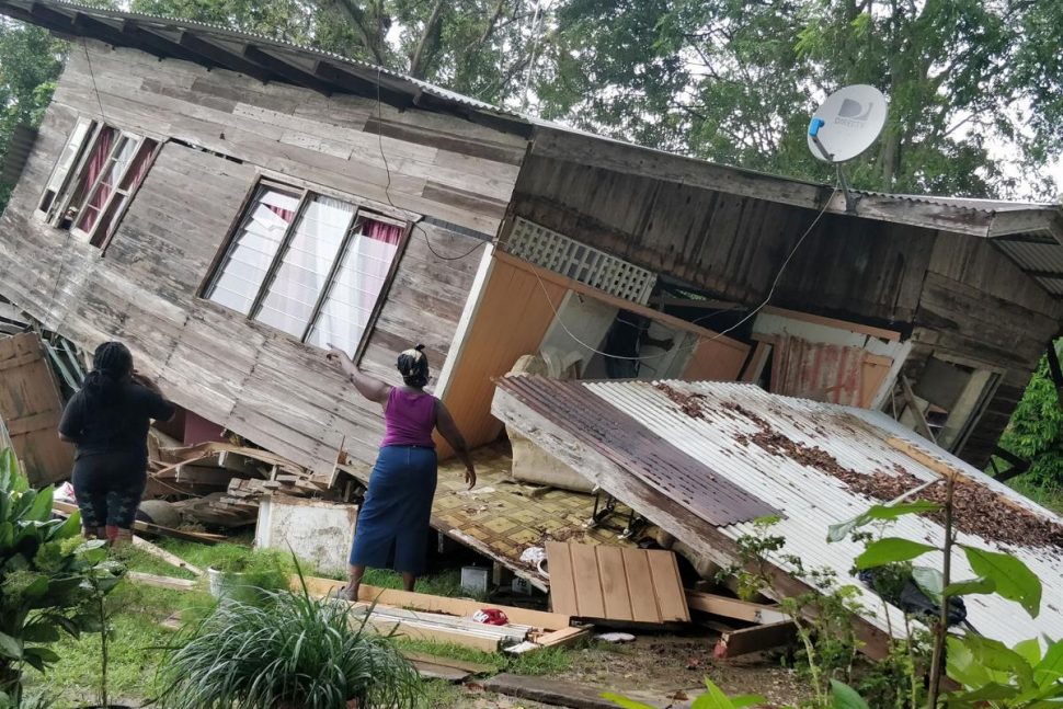 Residents of this house in St. Mary’s Village, Moruga, view the structural damage done to the house after it collapsed on Saturday. 